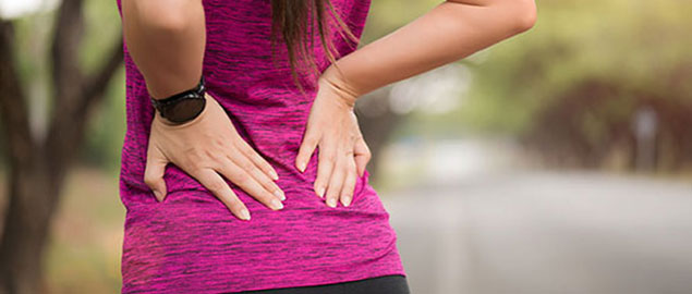 Woman suffering from low back pain Laurel, Bowie, Silver Spring, and Baltimore