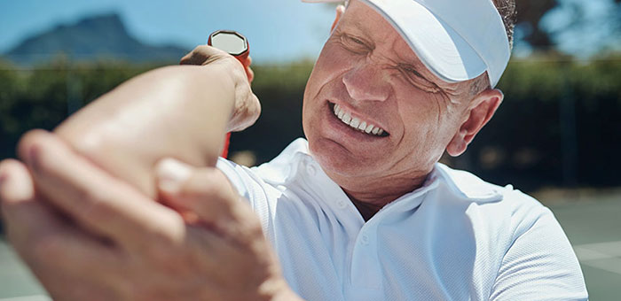 Patient needing tennis elbow treatment in Laurel, Bowie, Silver Spring, and Baltimore